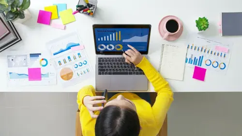 woman using a computer and reviewing data for her website