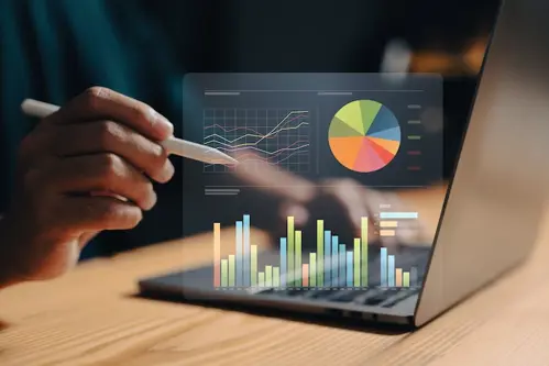 Man reviewing metrics for his PPC campaign on a laptop